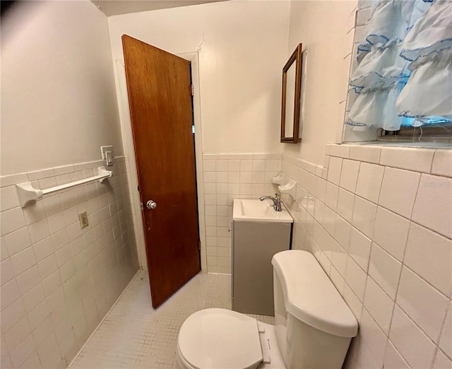 bathroom with vanity, tile walls, toilet, and tile patterned floors