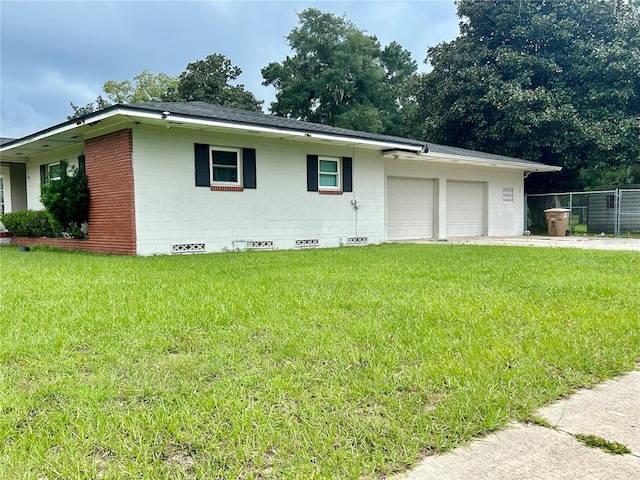 single story home with a garage and a front lawn