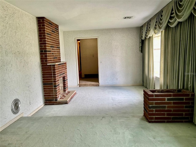 unfurnished living room with a textured ceiling and carpet