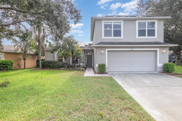 view of property featuring a front yard and a garage