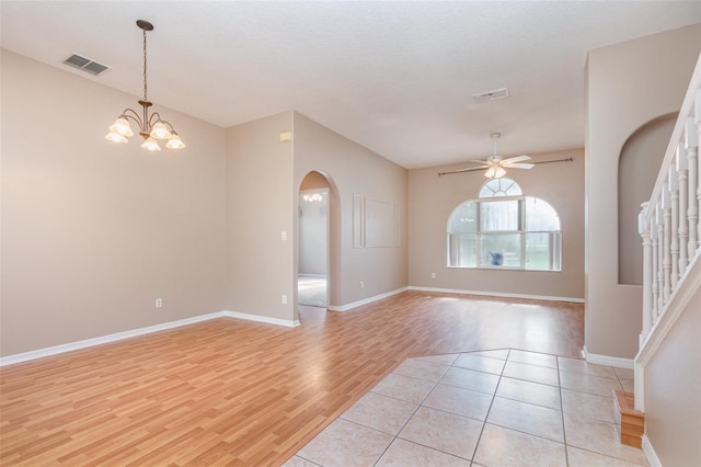 spare room with light hardwood / wood-style flooring, a textured ceiling, and ceiling fan with notable chandelier