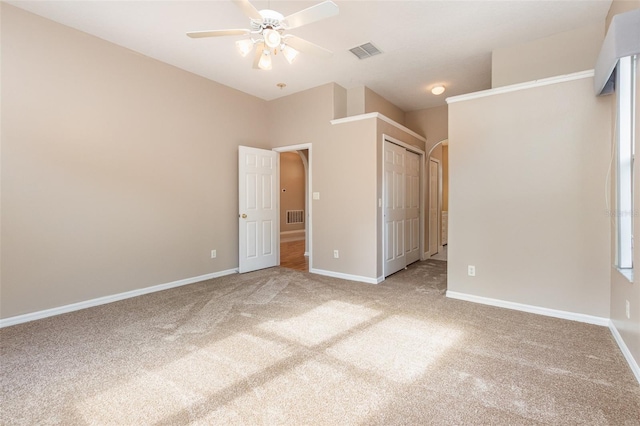 unfurnished bedroom with ceiling fan, carpet floors, and a closet