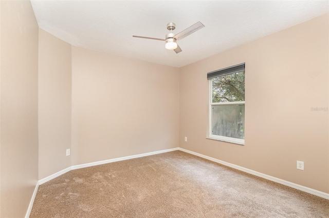 carpeted spare room featuring ceiling fan