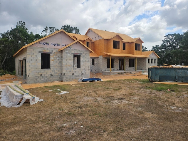 rear view of house featuring a pool