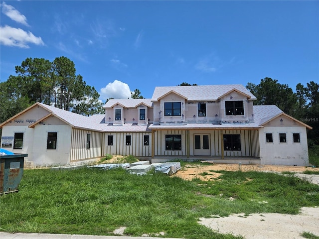 405 Long And Winding Rd, Howey In The Hills, FL 34737 - back of house with board and batten siding, a yard, and a shingled roof