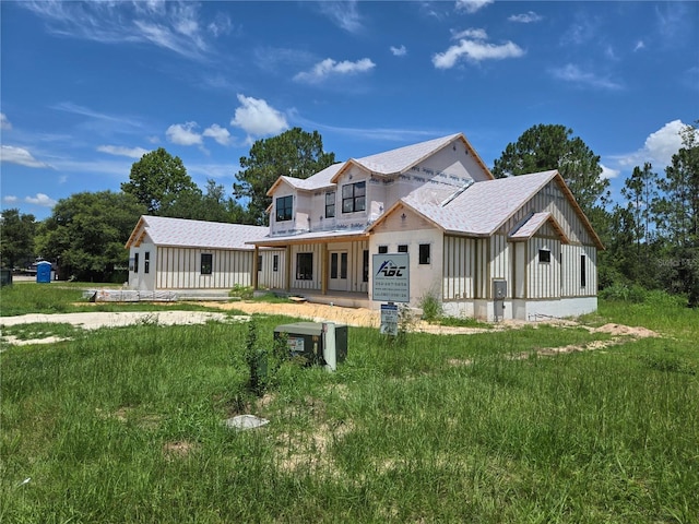 405 Long And Winding Rd, Howey In The Hills, FL 34737 - view of front of home featuring roof with shingles and board and batten siding