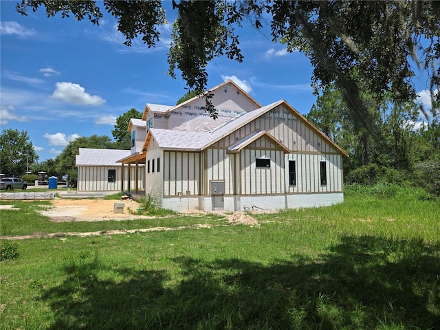 405 Long And Winding Rd, Howey In The Hills, FL 34737 - rear view of house featuring board and batten siding and a yard