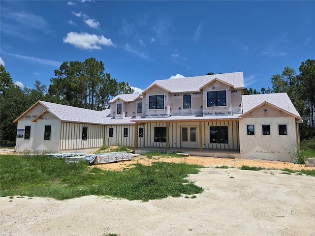 405 Long And Winding Rd, Howey In The Hills, FL 34737 - unfinished property with roof with shingles, french doors, and covered porch