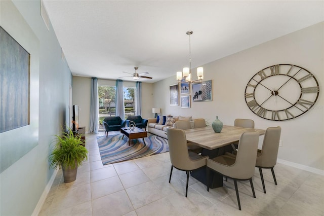 tiled dining space with ceiling fan with notable chandelier