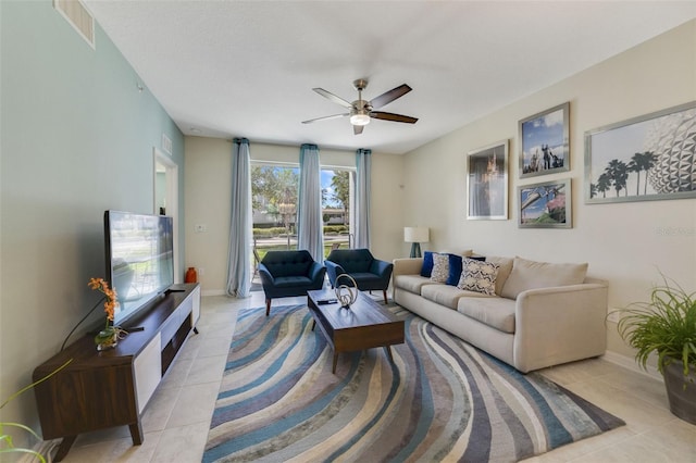 tiled living room featuring ceiling fan