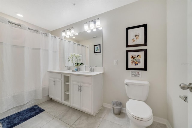 bathroom with vanity, toilet, and tile patterned floors