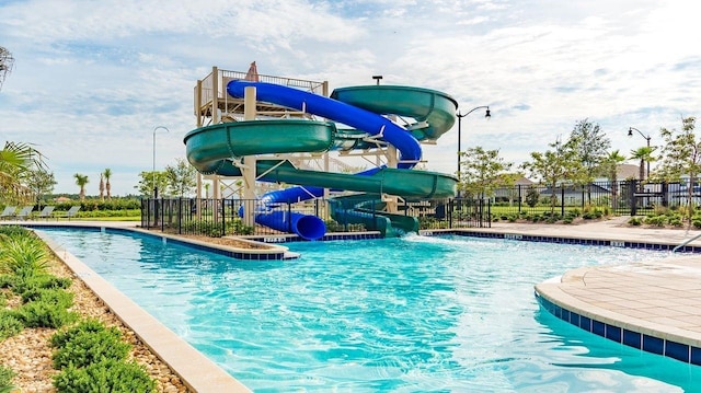 view of pool with a water slide