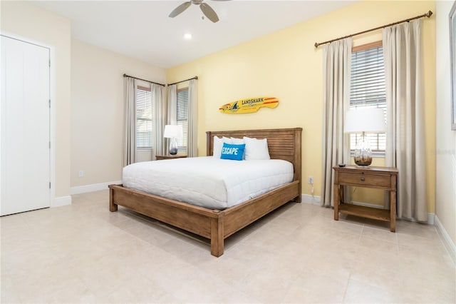 bedroom with ceiling fan and multiple windows