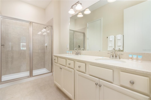 bathroom with vanity, a shower with shower door, and tile patterned floors