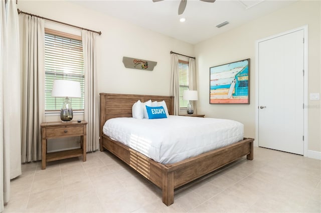 bedroom with ceiling fan, multiple windows, and light tile patterned flooring