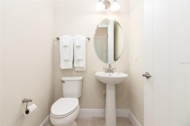 bathroom with sink, tile patterned flooring, and toilet