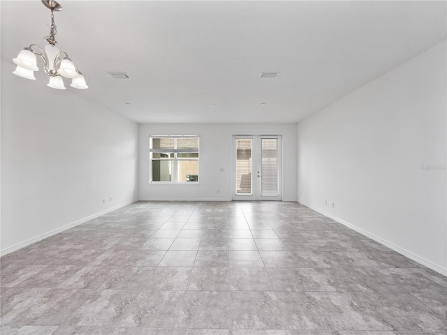 spare room featuring a notable chandelier