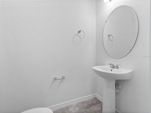 bathroom featuring toilet and tile patterned floors