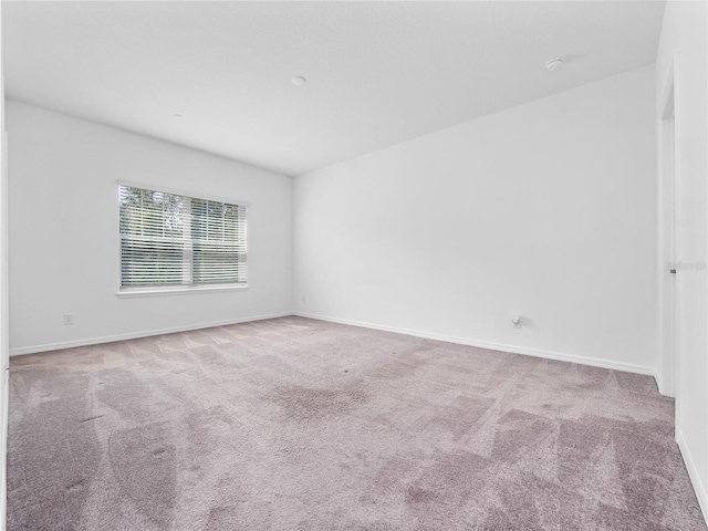 empty room featuring light carpet