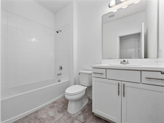 full bathroom with vanity, tiled shower / bath combo, and toilet