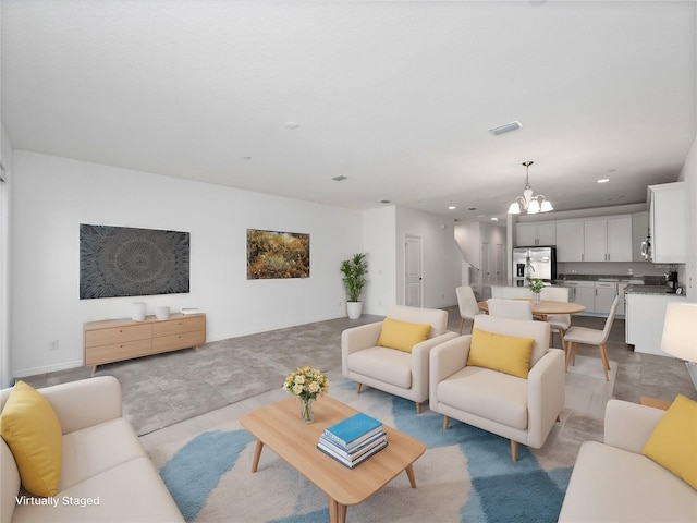 living room with a notable chandelier and light tile patterned floors