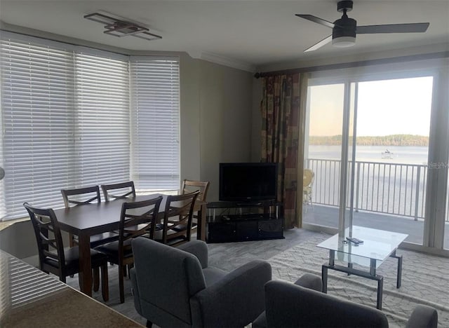 living room with ornamental molding, light carpet, and ceiling fan