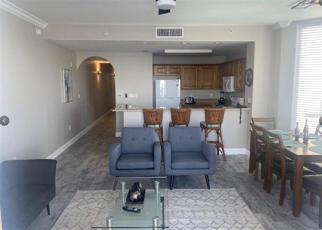 living room featuring ornamental molding and hardwood / wood-style flooring