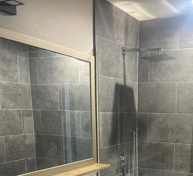 bathroom with a tile shower