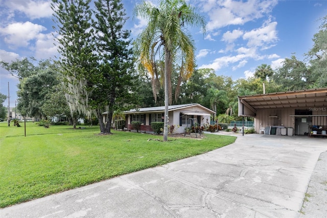 ranch-style house featuring a front yard and a carport