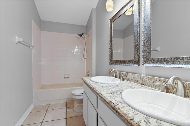 full bathroom with tiled shower / bath combo, tile patterned flooring, vanity, and toilet