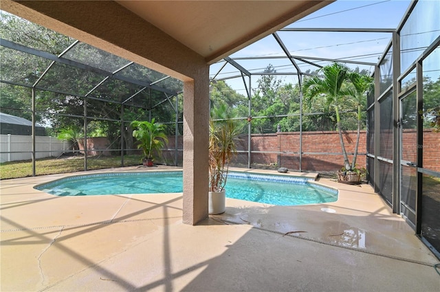 view of swimming pool with a patio and glass enclosure