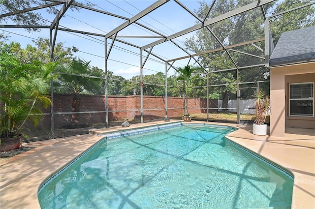 view of swimming pool with a lanai and a patio area