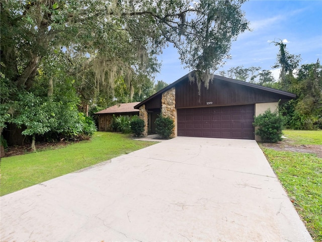 single story home featuring a front lawn and a garage