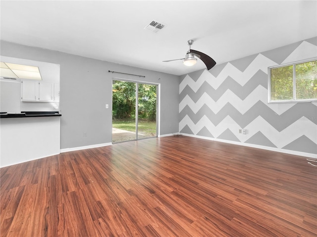 unfurnished living room featuring wood-type flooring and ceiling fan