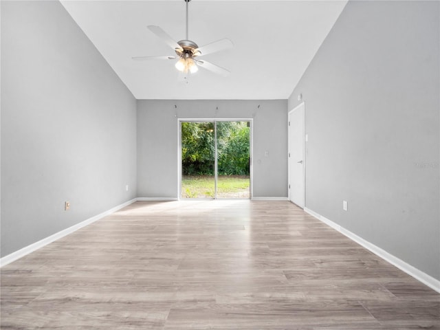 empty room with ceiling fan, light hardwood / wood-style flooring, and lofted ceiling