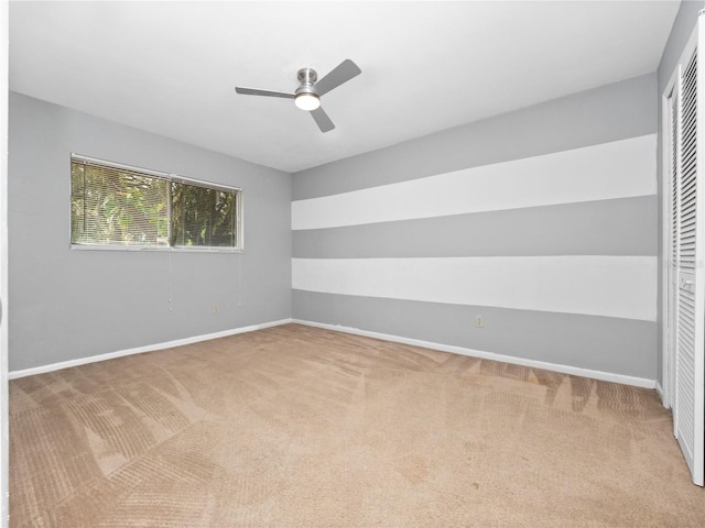 spare room featuring ceiling fan and carpet flooring