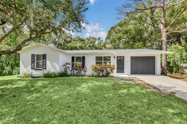 ranch-style house with a front yard and a garage