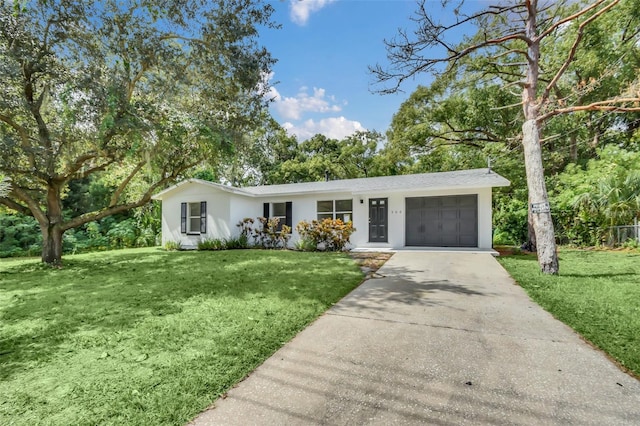 ranch-style house featuring a front yard and a garage