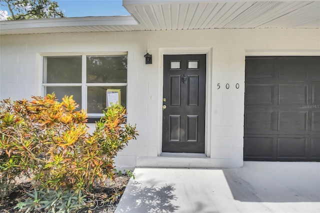 view of exterior entry with a garage