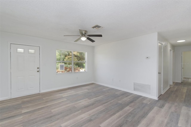 entryway featuring a textured ceiling, ceiling fan, and light hardwood / wood-style flooring