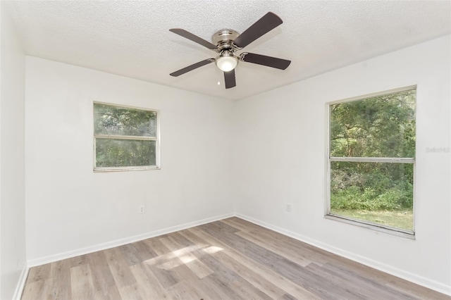 spare room with ceiling fan, a textured ceiling, and light hardwood / wood-style flooring