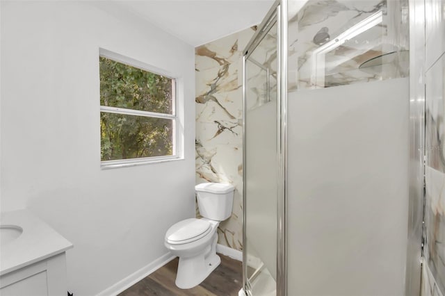 bathroom featuring hardwood / wood-style floors, an enclosed shower, vanity, and toilet