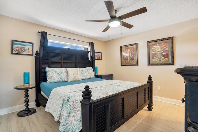 3150 N Atlantic Ave Unit 3-550, Cocoa Beach, FL 32931 - bedroom featuring light wood-type flooring, baseboards, a textured ceiling, and a ceiling fan