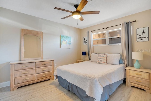 bedroom with ceiling fan and light hardwood / wood-style flooring