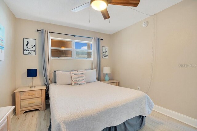 bedroom with light wood-type flooring and ceiling fan