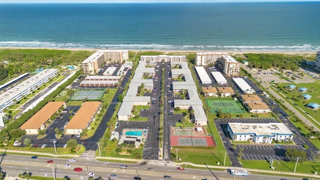 aerial view with a water view and a beach view