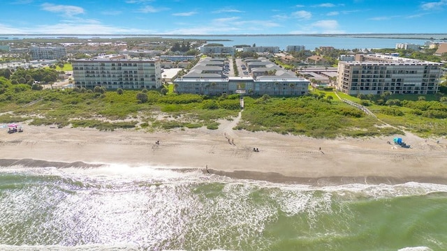 drone / aerial view with a beach view and a water view