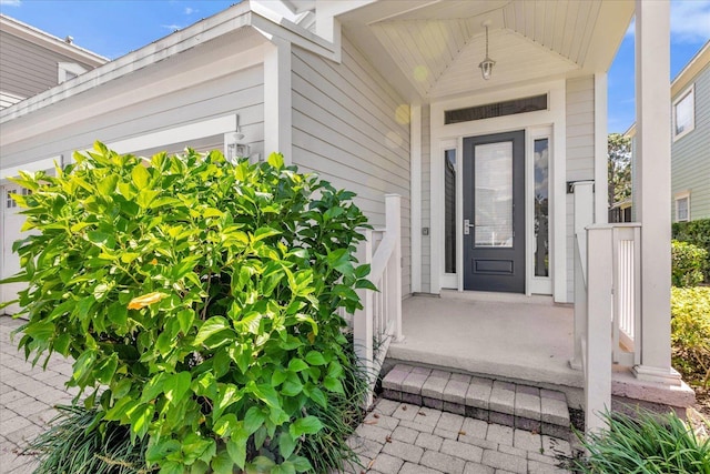 view of exterior entry featuring covered porch