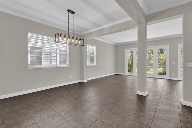 tiled empty room featuring a textured ceiling and crown molding