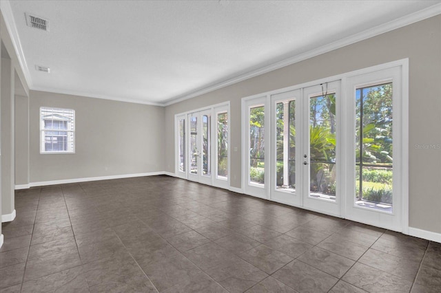 tiled empty room with a textured ceiling, plenty of natural light, french doors, and crown molding